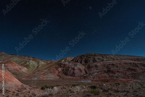 Amazing striped red mountains on a moon night