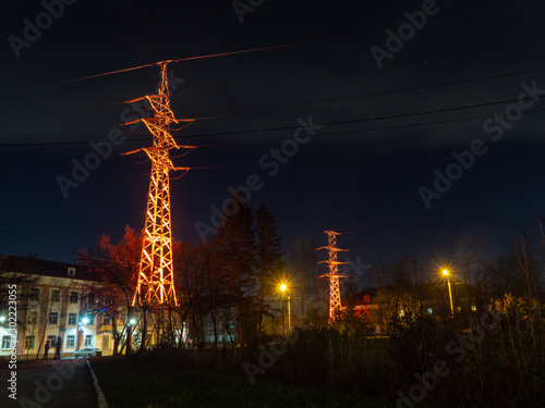 glowing towers of power lines at night