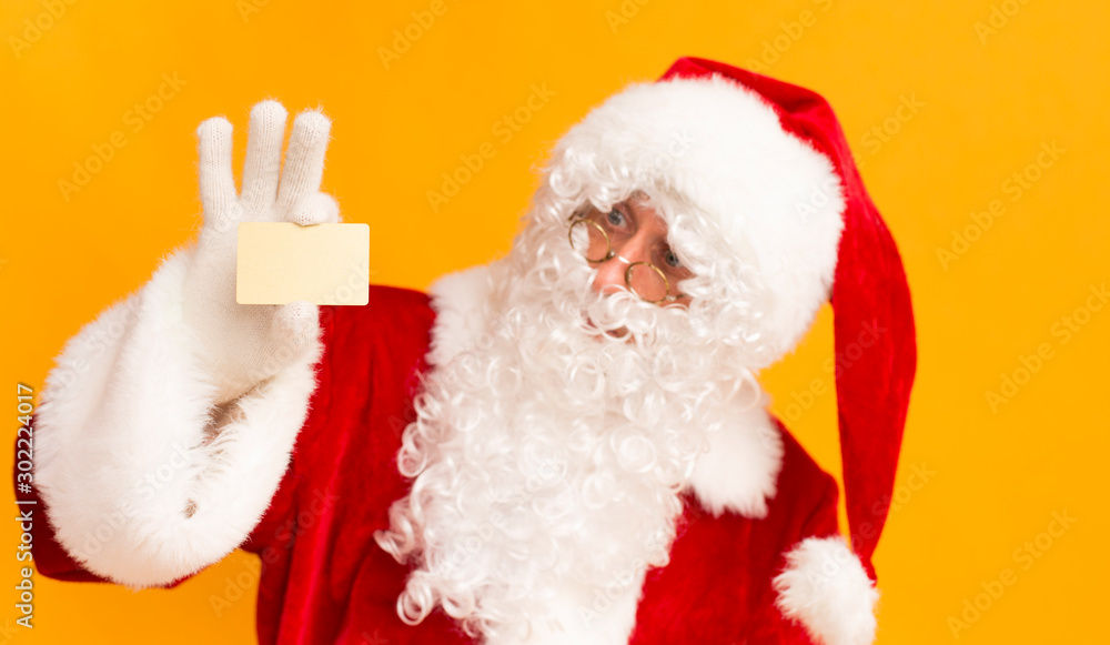 Santa Claus showing business card with copy space for text