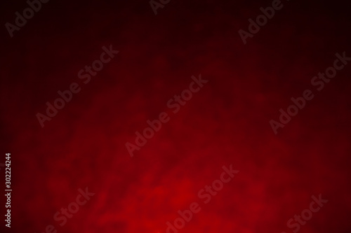 Black and red textural background in defocus