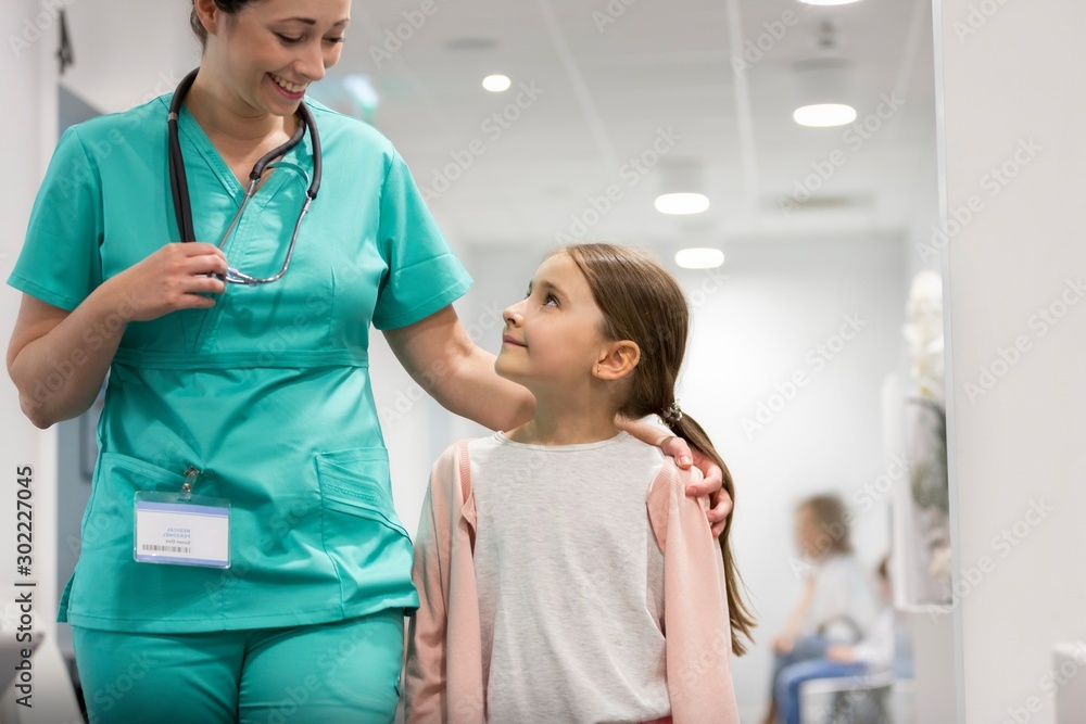 Nurse assisting child patient in clinic Nurse assisting child patient in clinic