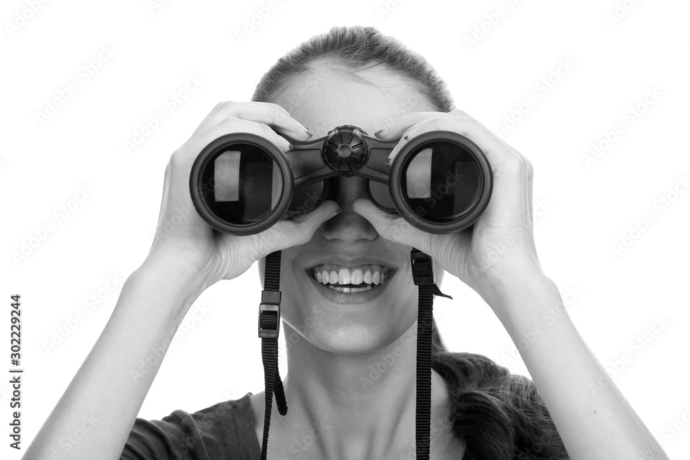 Young smiling woman looking through binoculars isolated on white background Young smiling woman looking through binoculars isolated on white background