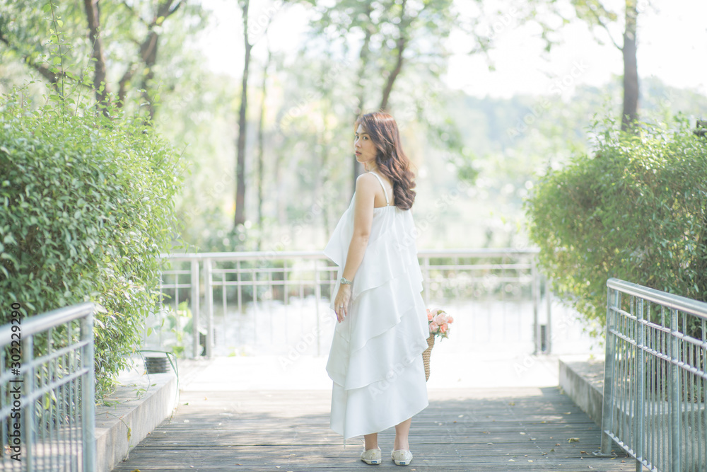 Beautiful asian womenwalking in city park sunshine day Beautiful asian womenwalking in city park sunshine day