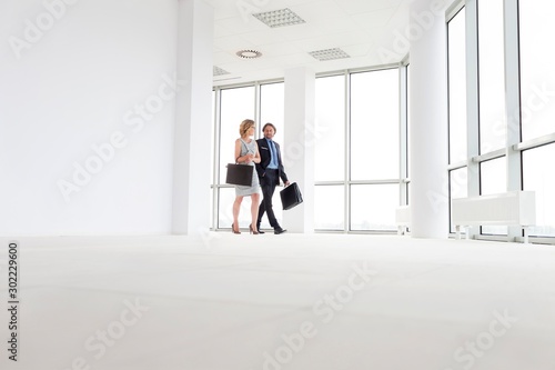 Business people walking in office hall