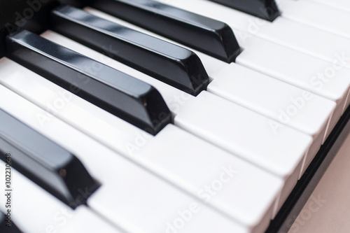 Close up photo of keyboard of piano or electronic digital  midi synthesizer. Side or top view. Musical classic instrument background  music player concept. Black and white key. Vintage style.