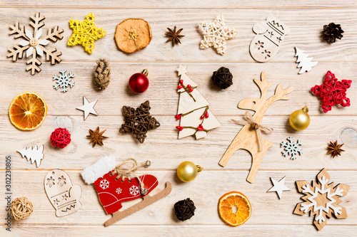 Top view of Christmas toys on wooden background. New Year ornament. Holiday concept