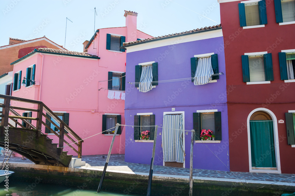 Fototapeta premium Burano island, Italy. View of the colored houses near the canal on the island of Burano, near Venice, Italy
