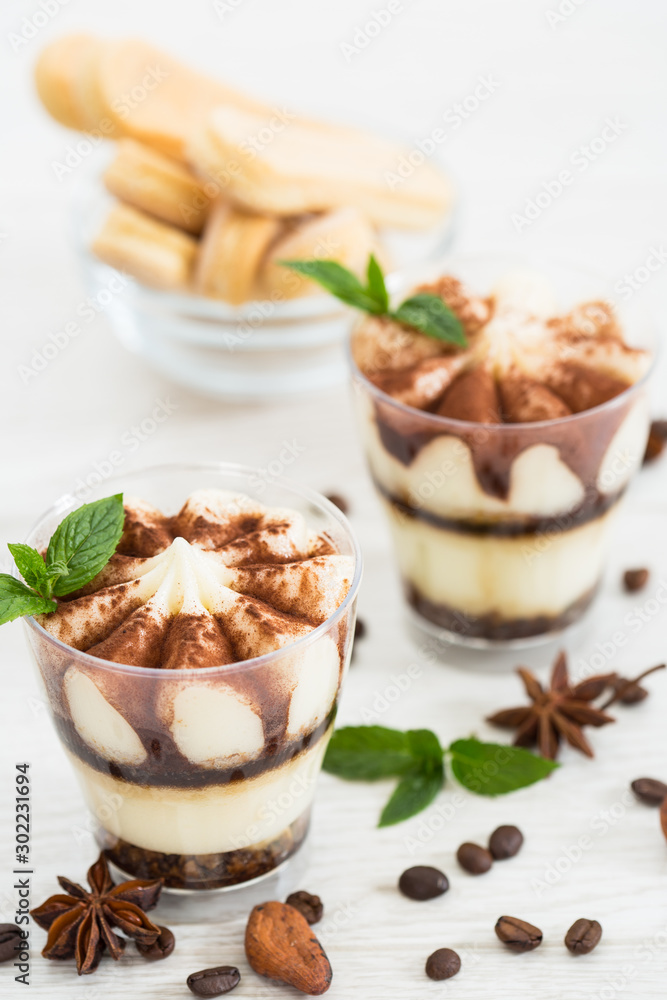 Tiramisu dessert with cocoa and mint in the glass Tiramisu dessert with cocoa and mint in the glass