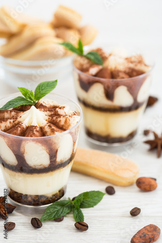 Tiramisu dessert with cocoa and mint in the glass