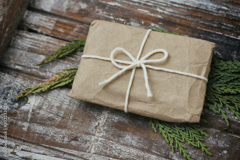 Gift box wrapped in brown craft paper and tie white white string