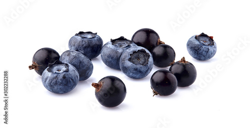 Black currant berries with blueberries on White Background isolated. Ripe black berries isolated.