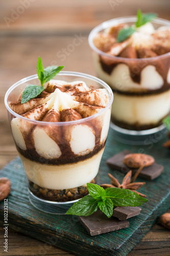 Tiramisu dessert with cocoa and mint in the glass