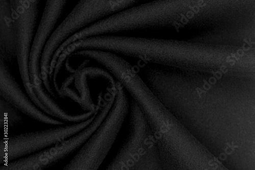 Background texture of black fleece, soft napped insulating fabric made of polyester, top view