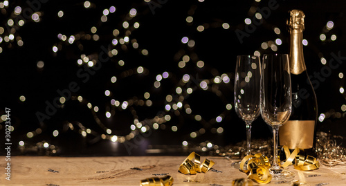 Valokuva New Year's Eve background with champagne bottle and glasses confetti and gold sn