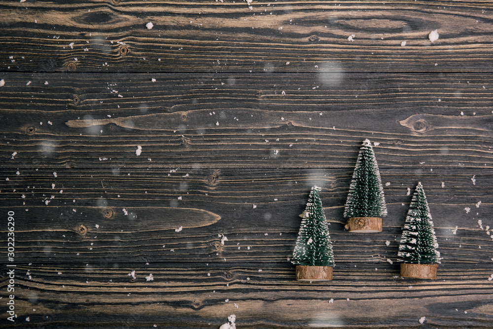 Naklejka premium Christmas holiday composition decoration with pine tree on wooden background, new year and xmas or anniversary with presents on wood table in season, top view or flat lay.