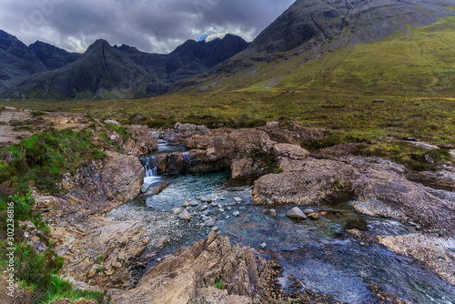 Small waterfall and creek along the walking route of The Fairy Pools in Glen Brittle on the Isle of Skye , Scotland