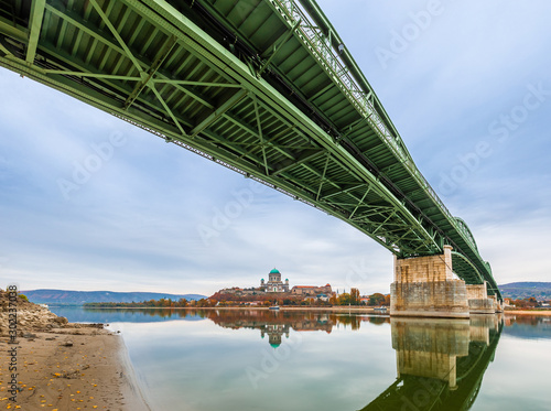 Esztergom, Hungary - Beautiful autumn morning at Esztergom with Maria Valeria Bridge and Basilica of the Blessed Virgin Mary at background at autumn time photo