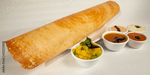 Paper Masala dosa is a South Indian meal served with sambhar and coconut chutney Selective focus - Image photo