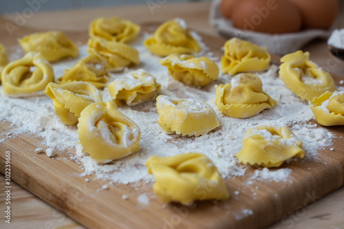 Italian pasta fresh raw tortellini covered with flour Ready to cook Italian food concept.