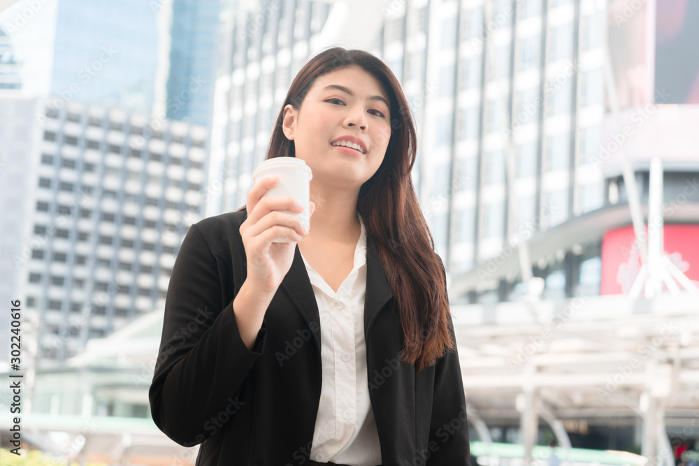 Asian business woman holding coffee papercup enjoy at outdoor office. Asian business woman holding coffee papercup enjoy at outdoor office.