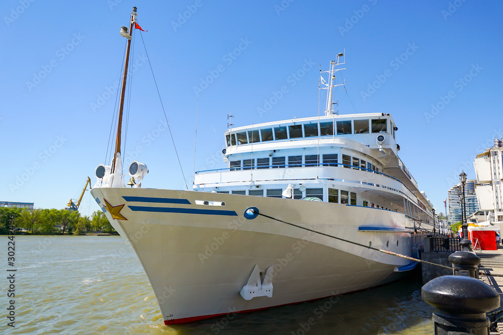 A large cruise ship with tourists on board stands at the pier on the central promenade of Rostov-on-Don. Russia