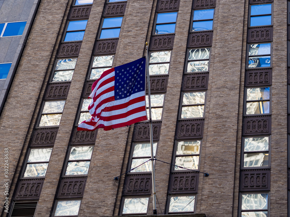 Close-up of the American flag of the United States. Stars and stripes honing over a building in New York City. United States of America.