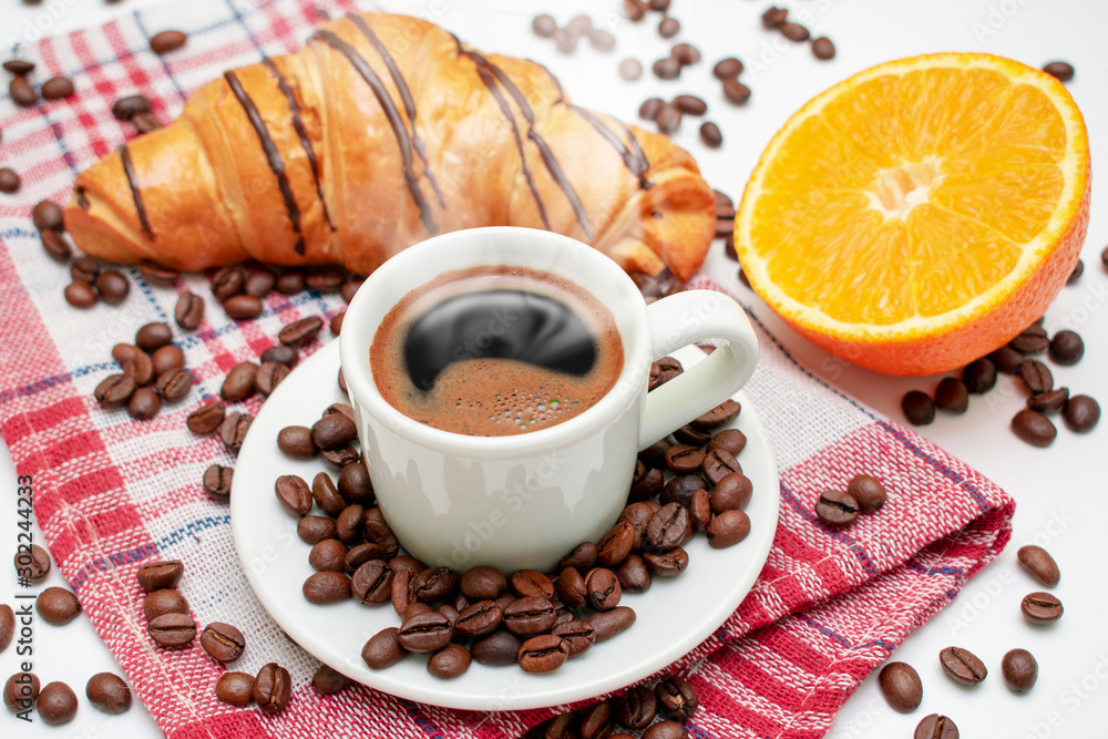 Cup of coffee with oranges and pastries. Coffee with croissant. Coffee for breakfast. Cup of coffee with oranges and pastries. Coffee with croissant. Coffee for breakfast.