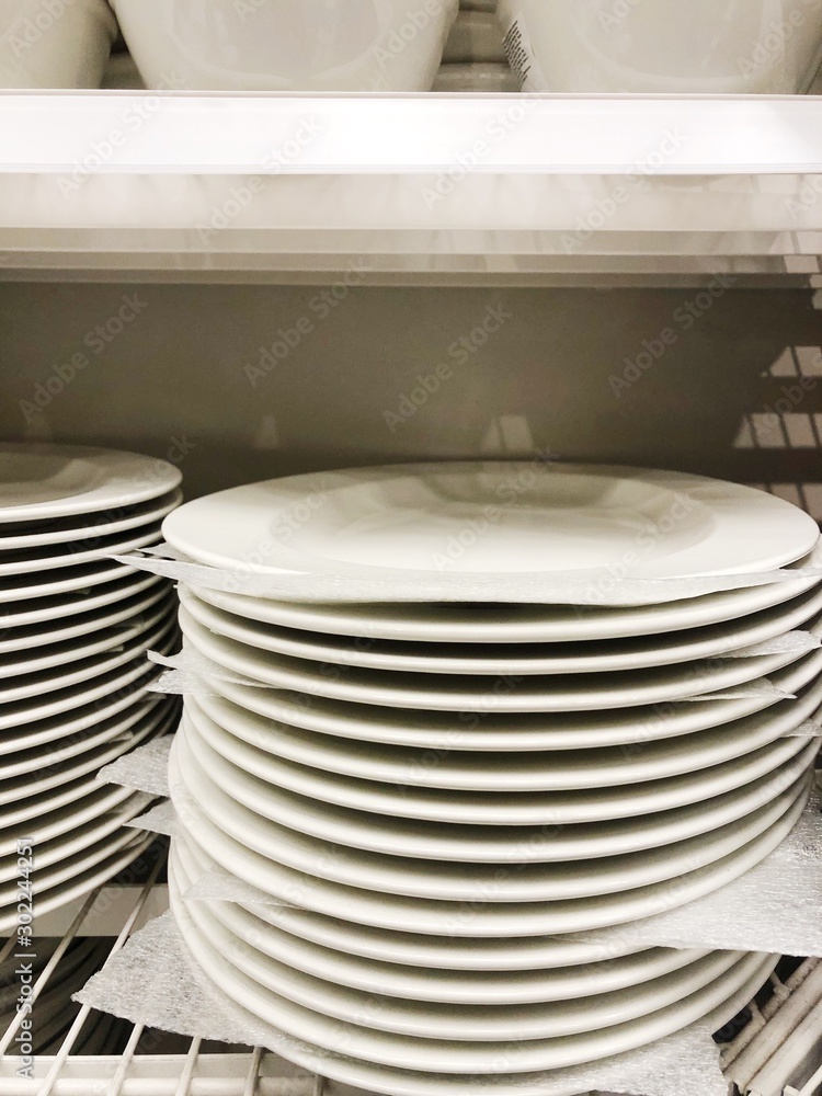 White plates on the shelves in the store