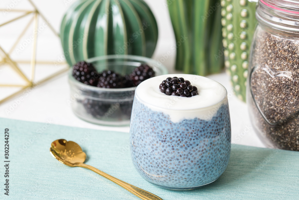 Blue chia seed pudding with blackberries in a glass Blue chia seed pudding with blackberries in a glass