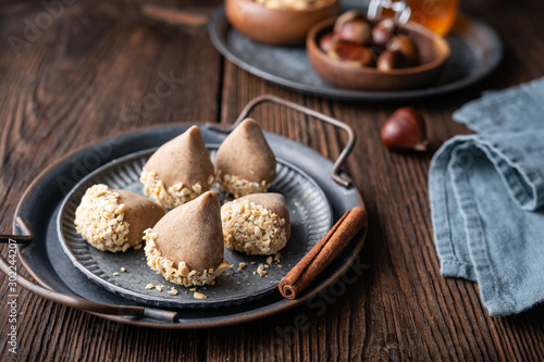 Traditional Korean no bake Yullan chestnut treat with honey and cinnamon, dipped in chopped peanuts