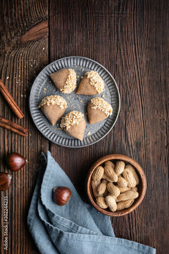 Traditional Korean no bake Yullan chestnut treat with honey and cinnamon, dipped in chopped peanuts photo