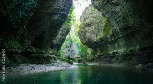 mountain river and tourists in a boat in a canyon in Georgia photo
