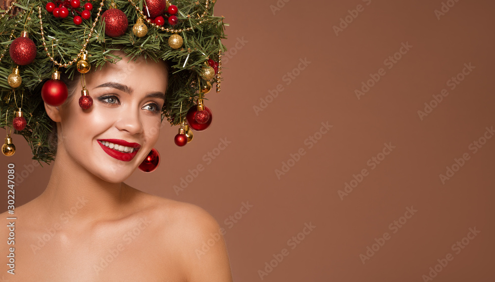 Cute girl with christmas wreath on her head. Brown background.