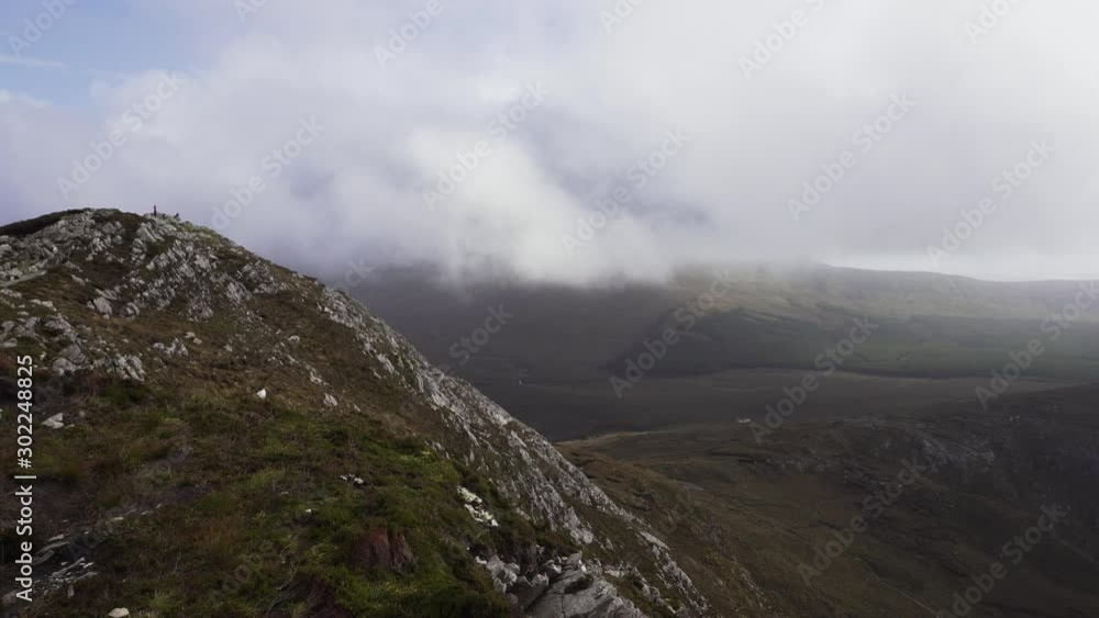 Mountain summit next to clouds in moody landscape of northern europe Mountain summit next to clouds in moody landscape of northern europe