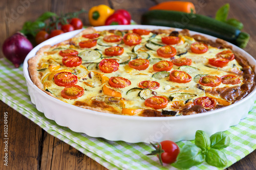 Quiche with tomatoes, spinach and feta cheese photo