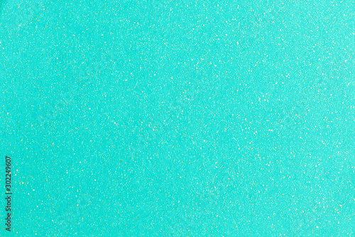 Silver sparkles on turquoise pastel trendy background.