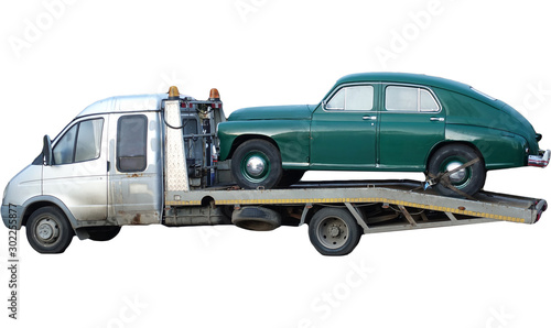 Russian tow truck transports a vintage passenger car of the Stalin era.