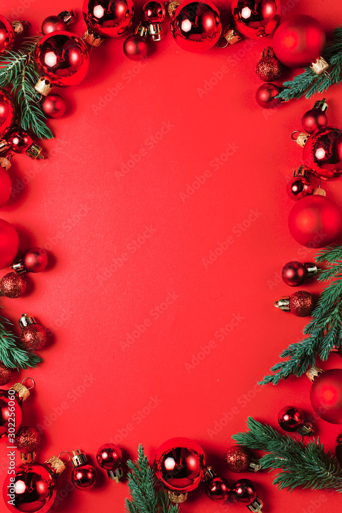 Christmas composition. Christmas red decorations on red background. Flat lay. Christmas and happy new year concept for Christmas promotion banner