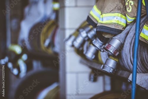 Canvas Print Closeup shot of firefighters clothes and hose with a blurred background