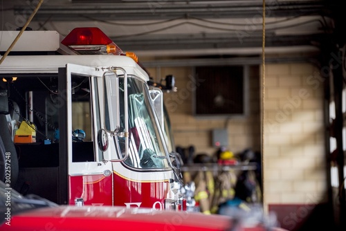 Canvas Print Closeup shot of a firetruck with an open door and a blurred background