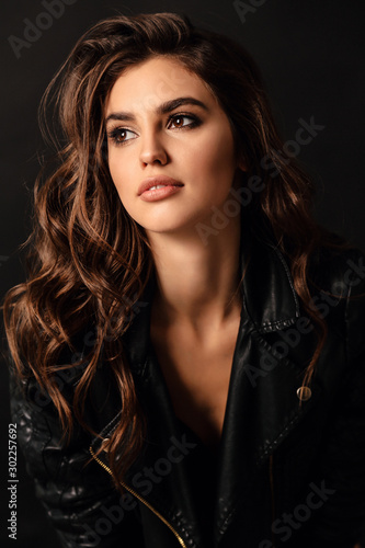 Canvas Print beautiful sexy woman in elegant leather jacket posing in studio