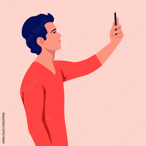 A young man takes a selfie and holds his smartphone in his hand. A blogger is photographed for a social network. Vector flat illustration