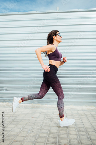 Beautiful woman running in the city. Fitness  workout  sport  lifestyle concept