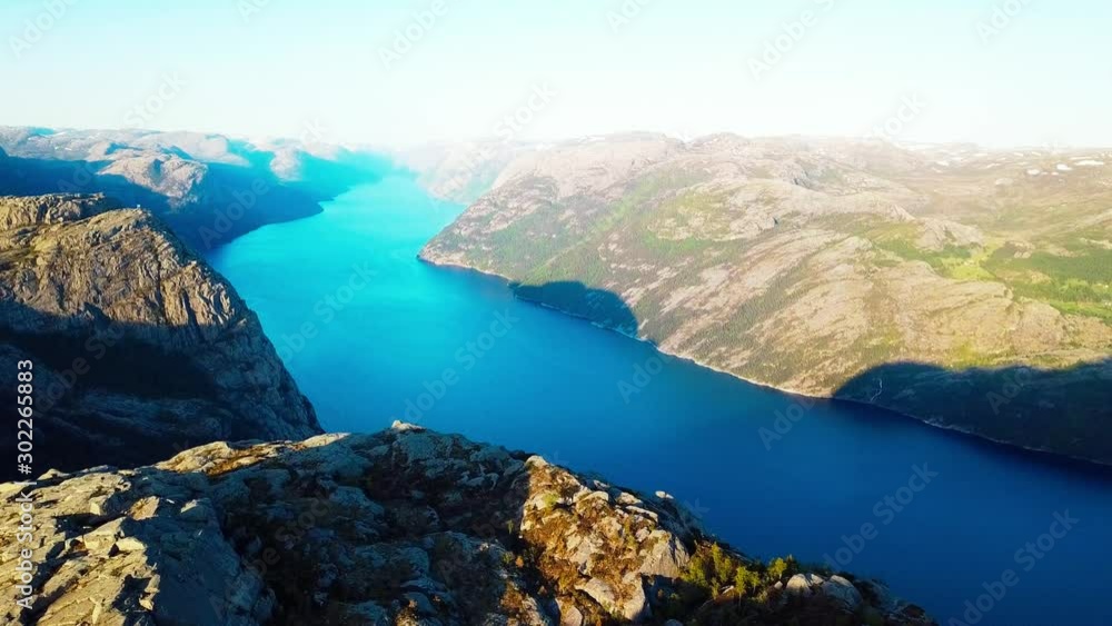 A drone flight over the Lysefjorden, in the area of Preikestolen, with the side view on the Pulpit Rock, Norway. Hiking paradise, that gives you a lot of freedom. Beautiful weather. Hikers bucket list A drone flight over the Lysefjorden, in the area of Preikestolen, with the side view on the Pulpit Rock, Norway. Hiking paradise, that gives you a lot of freedom. Beautiful weather. Hikers bucket list