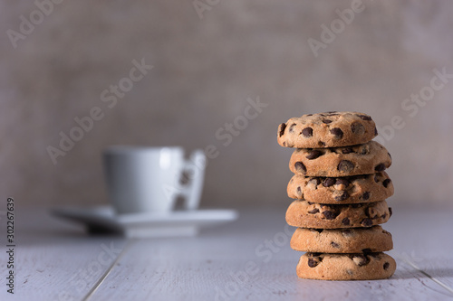 cup of coffee and cookies on wooden table