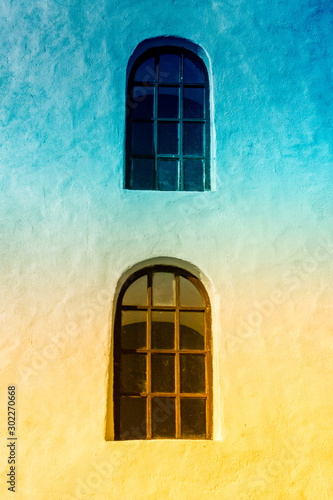 Blue and Yellow Windows on an Ancient White Building