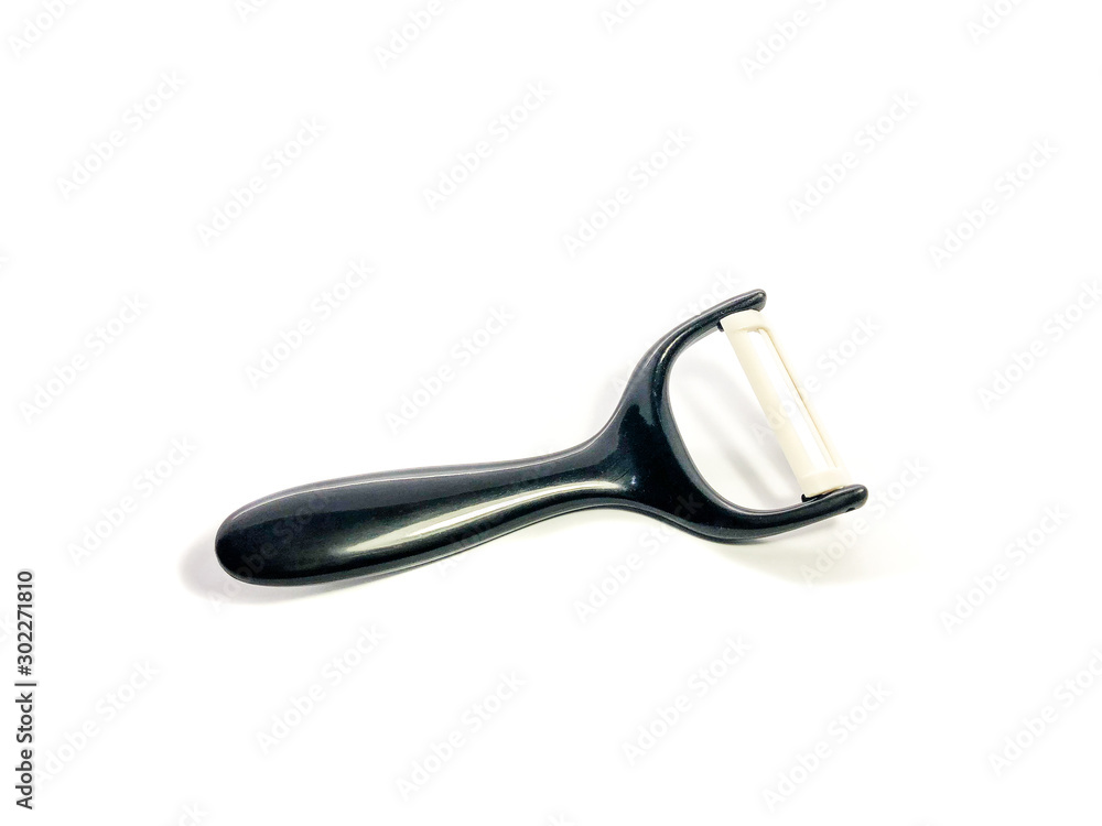 Black peeler isolated on white background. Ceramic peeler for vegetables and fruits. Black peeler isolated on white background. Ceramic peeler for vegetables and fruits.