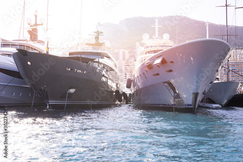 Super yachts moored in Monaco harbour  Monaco yacht show © DiMar