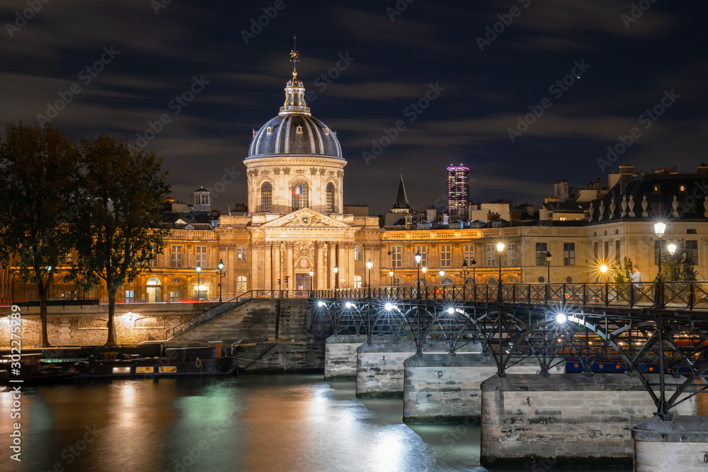 Paris night cityscape with The Institute of France and bridge of Arts
