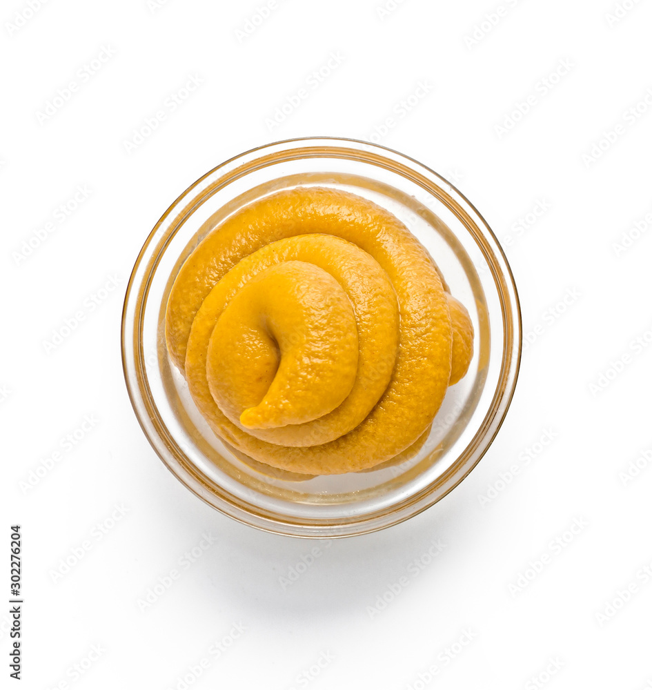Fresh spicy mustard in a glass bowl on a white background Fresh spicy mustard in a glass bowl on a white background